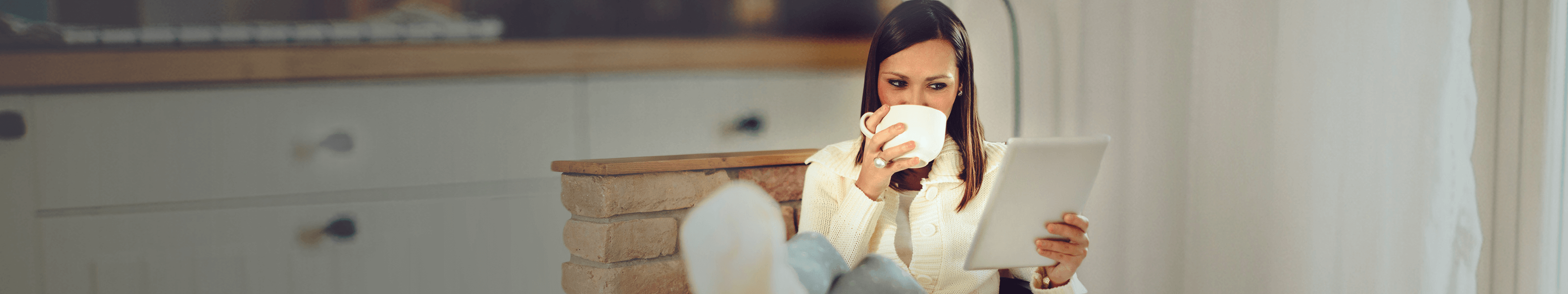 SunTrust Fraud and Security woman drinking coffee and looking at her tablet