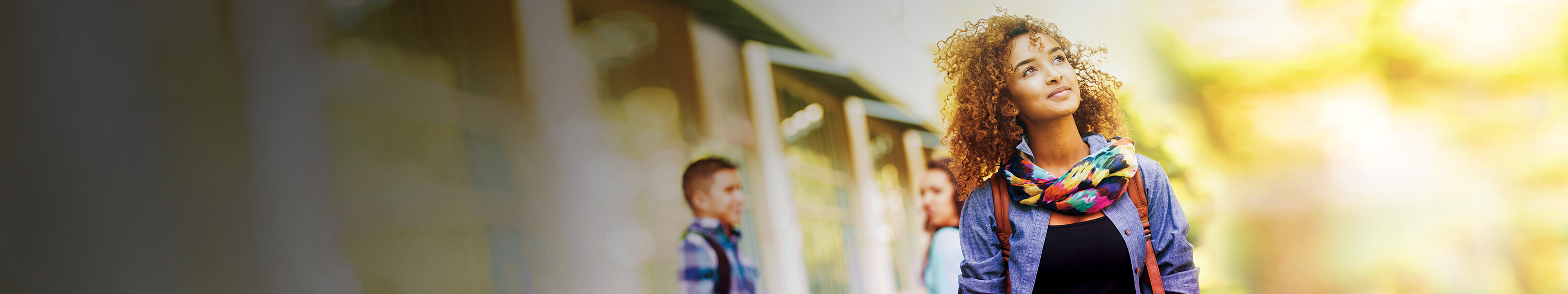 A young college-age female walking on campus.