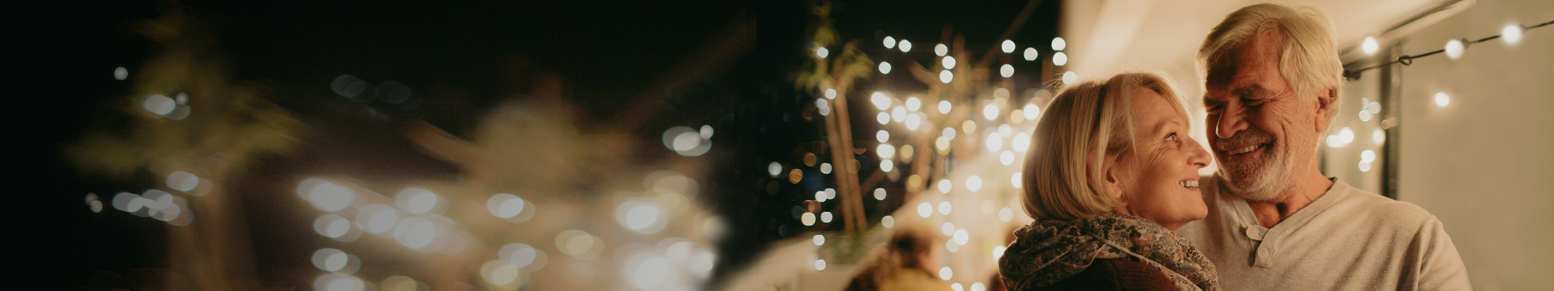 Couple walking outside under Christmas lights Talk to us about homebuying