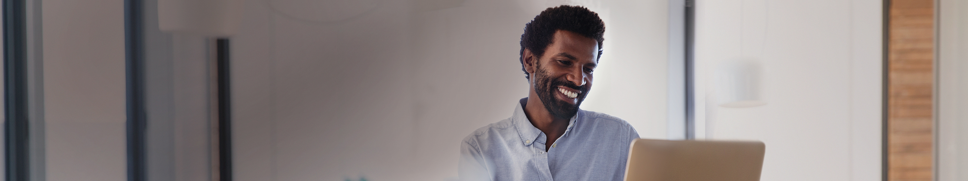 Man working on laptop, smiling. Man working on laptop, smiling.