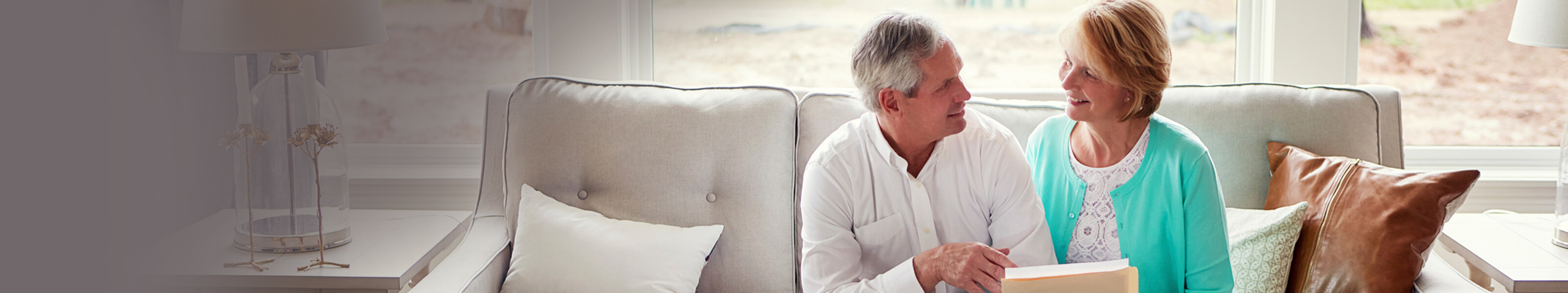 Advantage Money Market Savings older couple sitting on the couch reviewing documents
