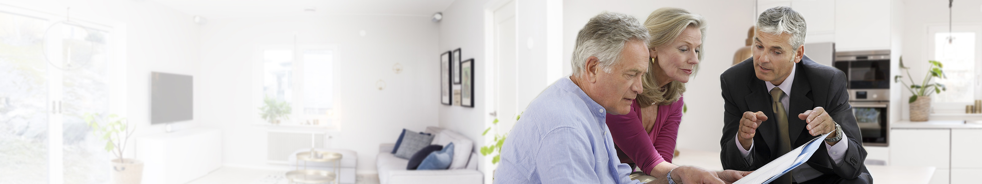 A financial advisor sits with a senior couple.