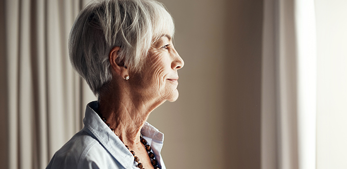 Beautiful mature woman looking out the window, “Life Insurance and Charitable Giving”