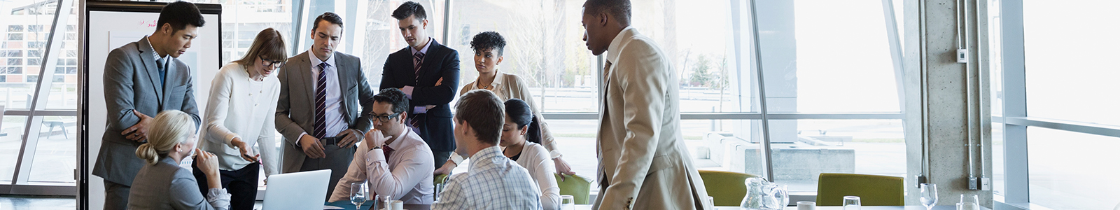 Employees huddled around a computer.